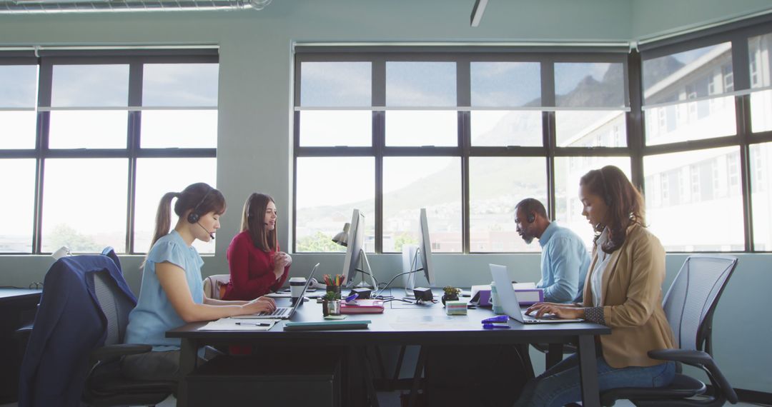 Diverse Business Team Working with Headsets in Modern Office