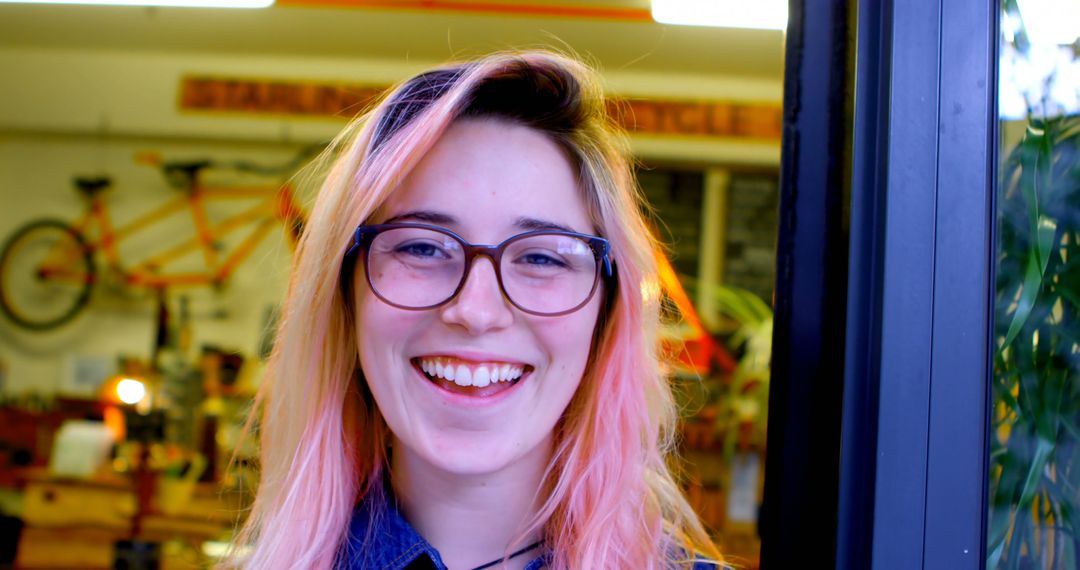 Smiling Woman with Pink Hair and Glasses Indoors - Free Images, Stock Photos and Pictures on Pikwizard.com