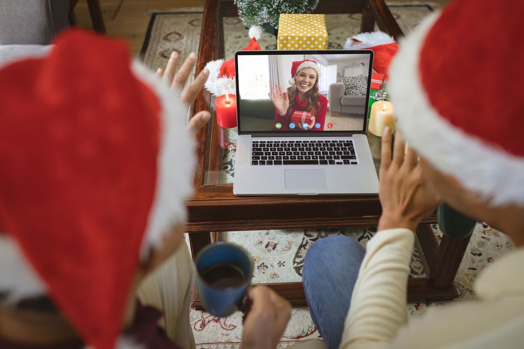 Diverse couple with santa hats having video call with happy caucasian woman - Free Images, Stock Photos and Pictures on Pikwizard.com
