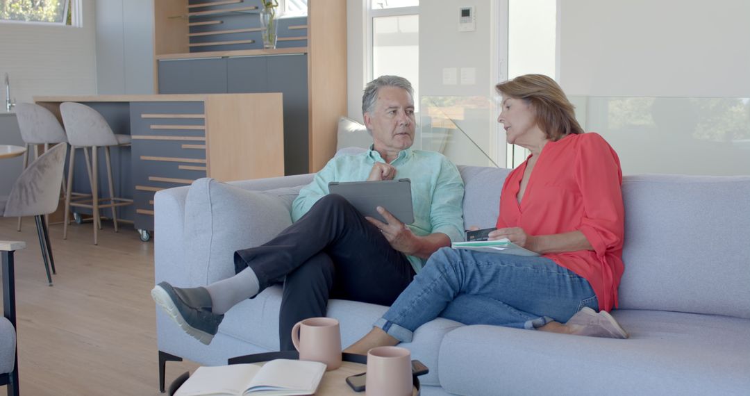 Senior Couple High-Fiving and Bonding on Comfortable Couch