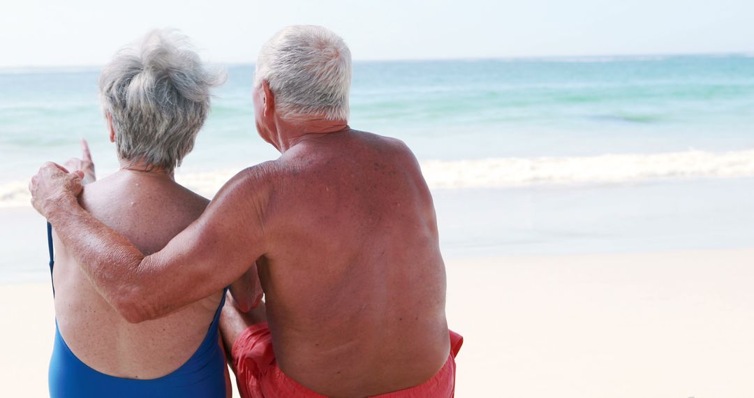 Senior Couple Relaxing on Beach, Facing Ocean Waves - Free Images, Stock Photos and Pictures on Pikwizard.com