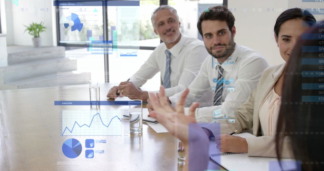 Business Team Analyzing Data on Clear Screen in Office Meeting