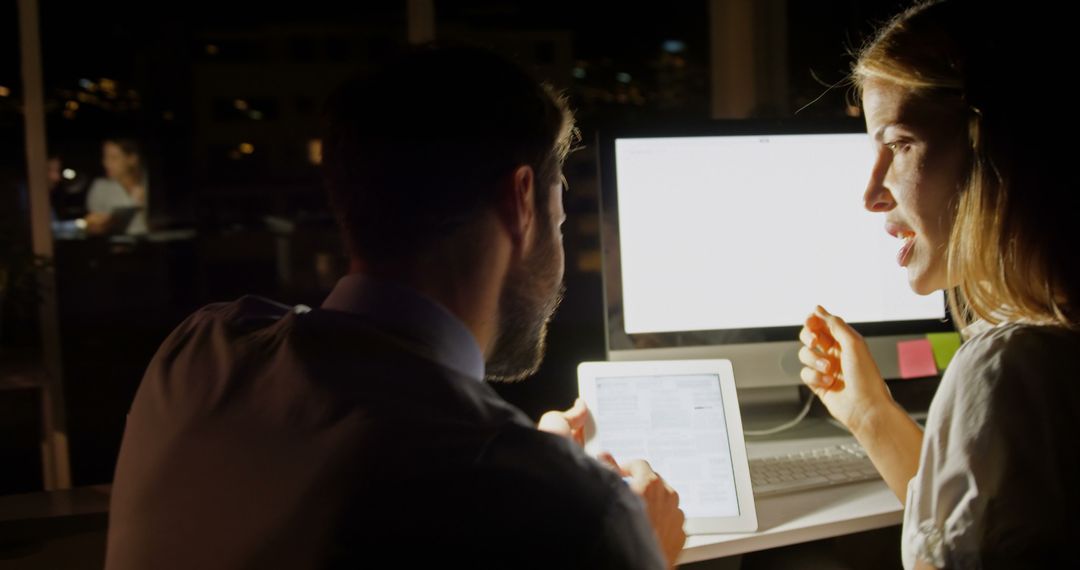 Professionals in Intense Discussion Working Late at Office