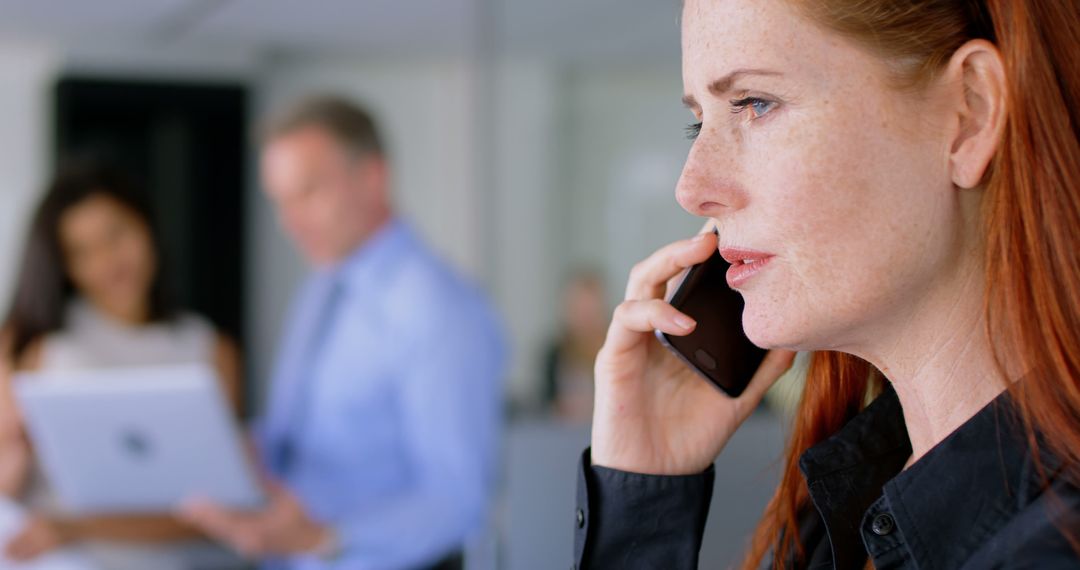 Focused Businesswoman Negotiating on Phone in Office Environment - Free Images, Stock Photos and Pictures on Pikwizard.com