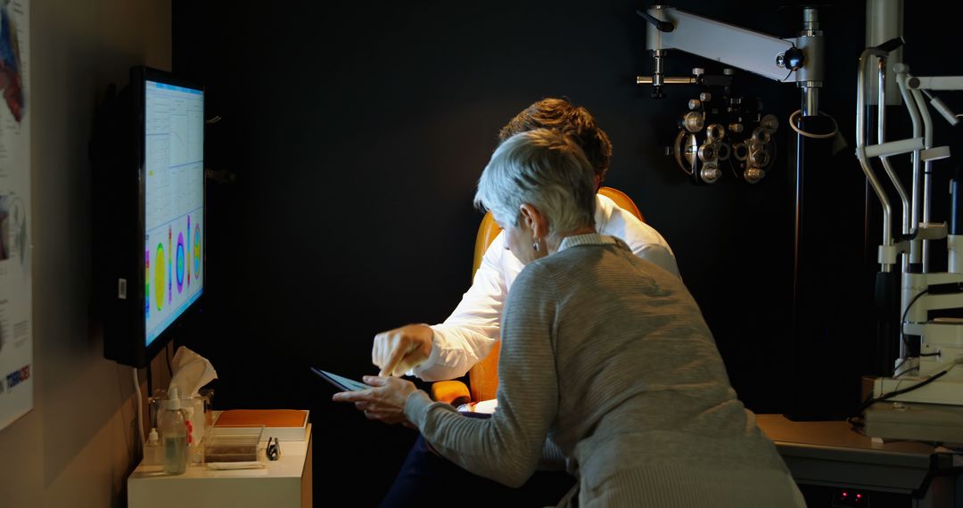 Optometrist Assisting Elderly Patient With Vision Test on Tablet - Free Images, Stock Photos and Pictures on Pikwizard.com