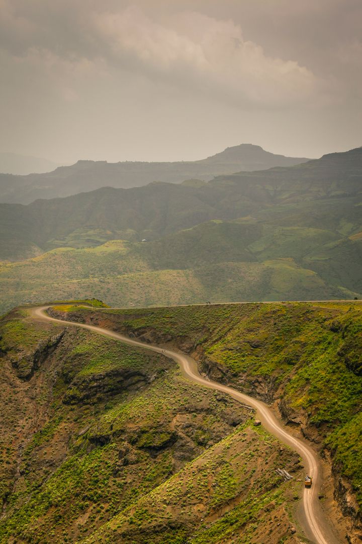 Winding Road Through Lush Mountain Landscape on Cloudy Day - Free Images, Stock Photos and Pictures on Pikwizard.com