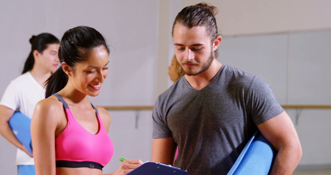 Fitness Instructor Discussing Plan with Female Client at Gym - Free Images, Stock Photos and Pictures on Pikwizard.com