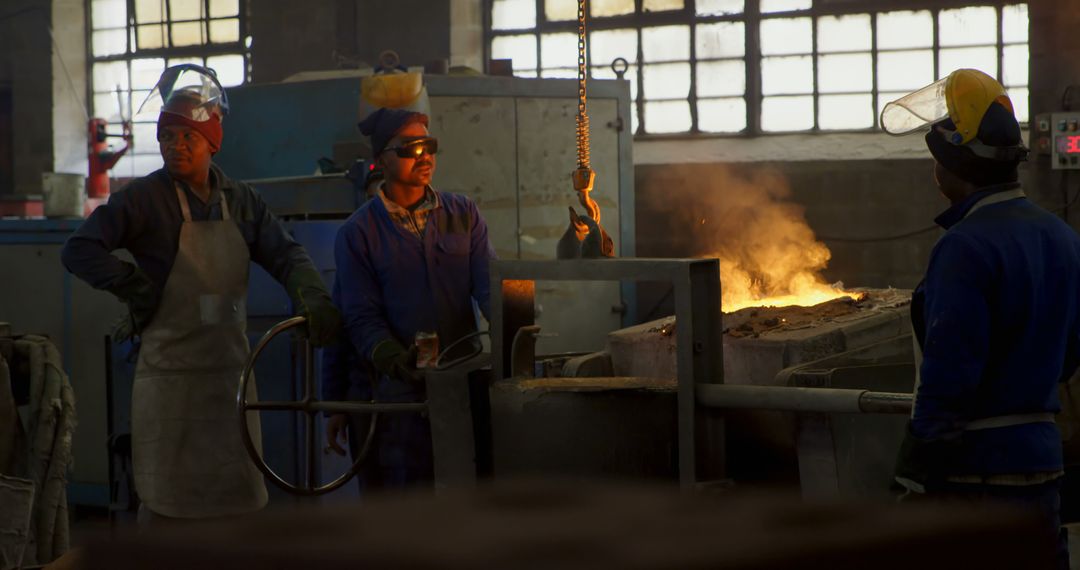 Industrial Workers Observing Molten Metal in Foundry - Free Images, Stock Photos and Pictures on Pikwizard.com