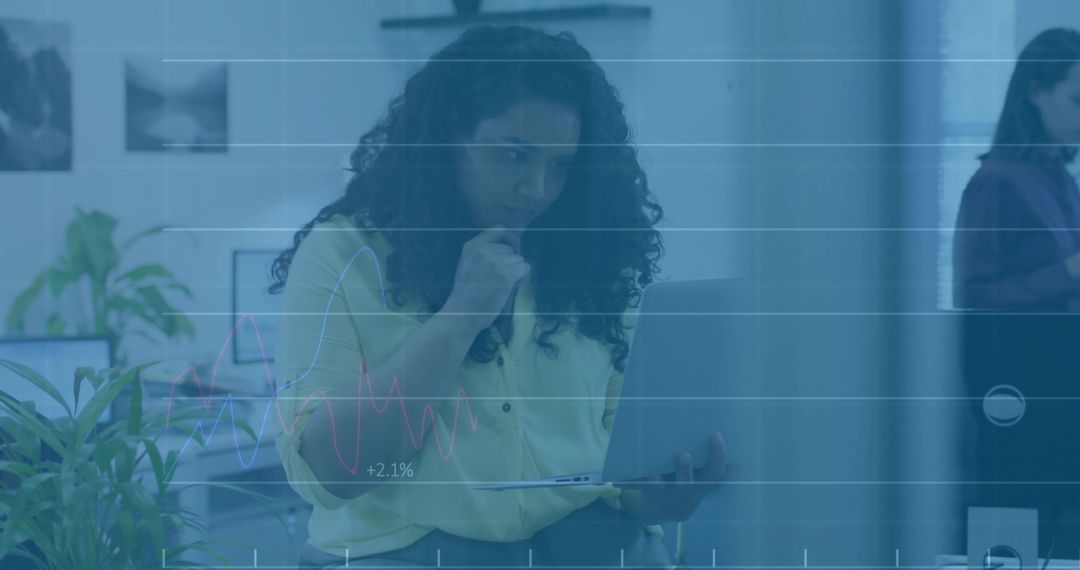 Businesswoman Analyzing Growth Metrics on Laptop with Graph Overlay