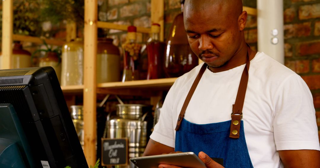 Supermarket Staff Using Tablet at Checkout Counter