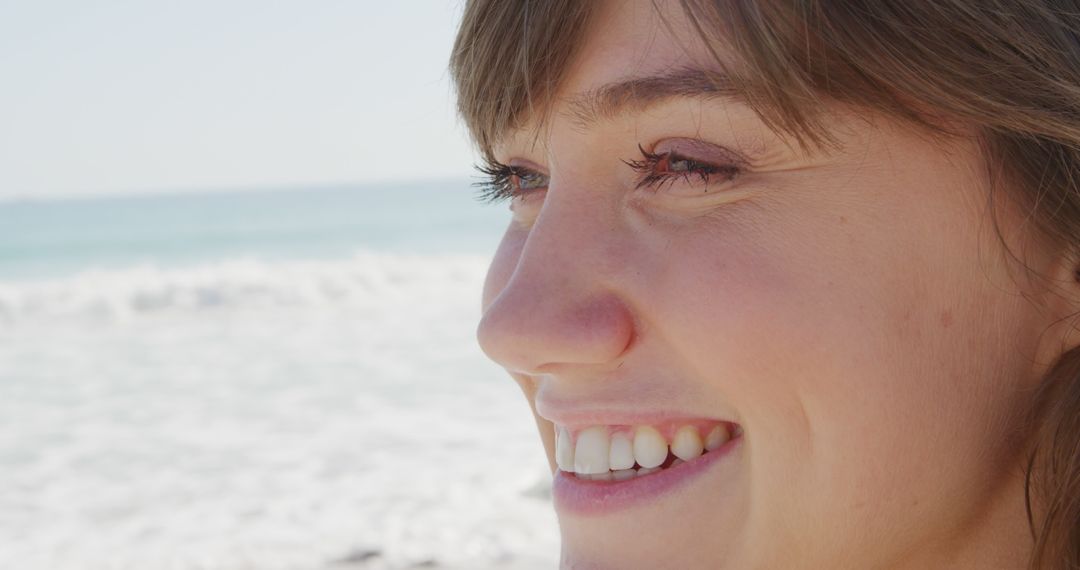 Young Woman Smiling by Beach During Summer Day - Free Images, Stock Photos and Pictures on Pikwizard.com