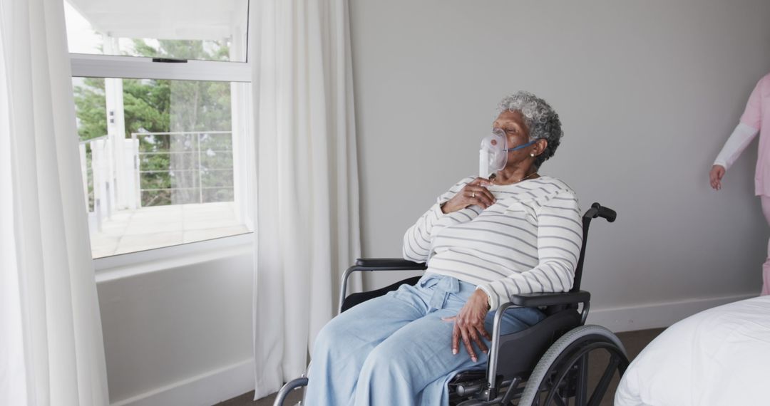 Elderly Woman in Wheelchair with Oxygen Mask Looking Out Window - Free Images, Stock Photos and Pictures on Pikwizard.com