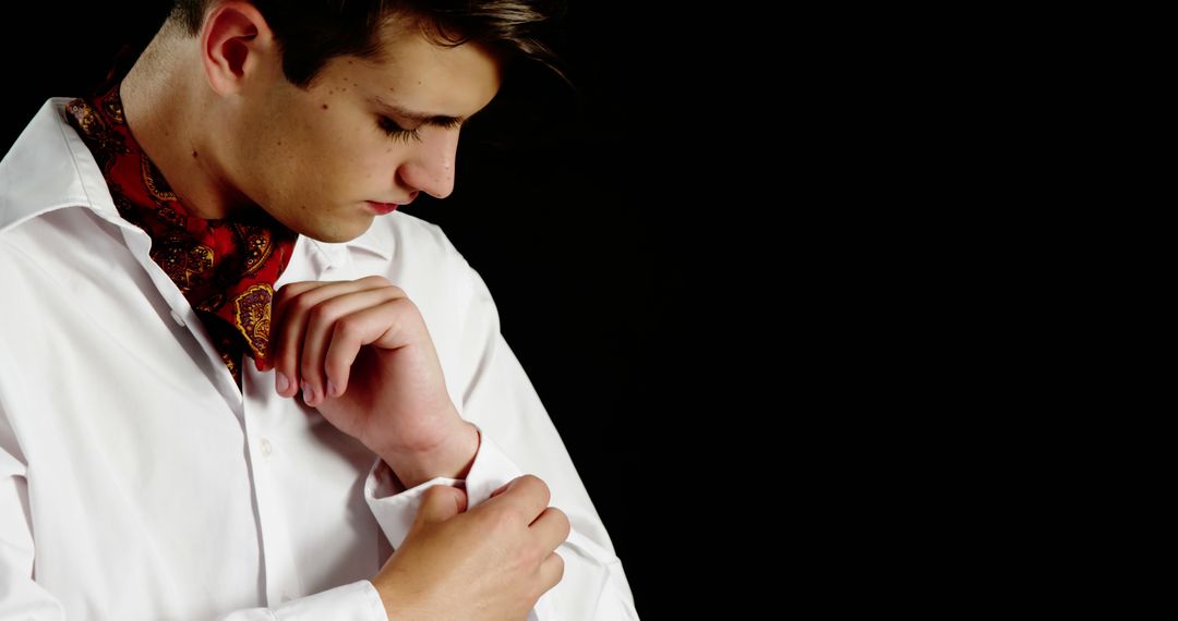 Man Wearing White Shirt and Red Cravat Adjusting Cuff - Free Images, Stock Photos and Pictures on Pikwizard.com