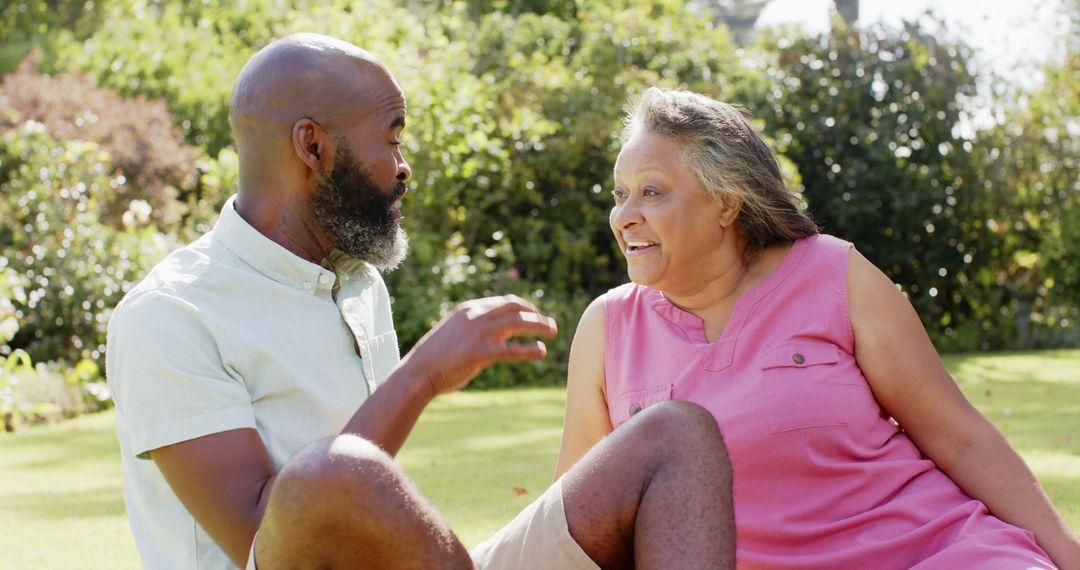 Smiling Senior Friends Enjoying Conversation in Sunny Park