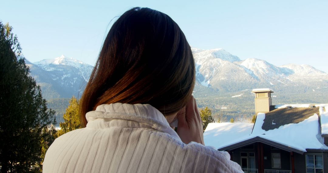 Woman Enjoying Scenic Winter Mountain View from Balcony - Free Images, Stock Photos and Pictures on Pikwizard.com