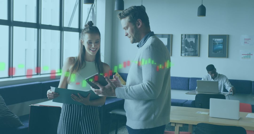 Colleagues Analyzing Data Together in Modern Office Environment