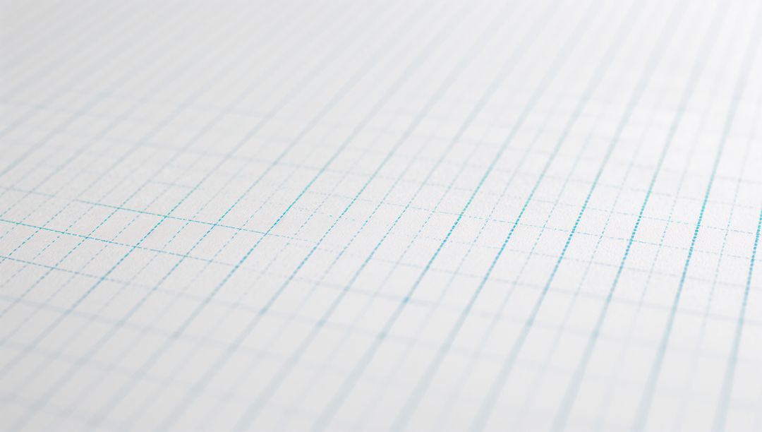 Diagonal Close-Up Featuring Blue Grid Graph Paper on Desk for Design and Stationery Backgrounds