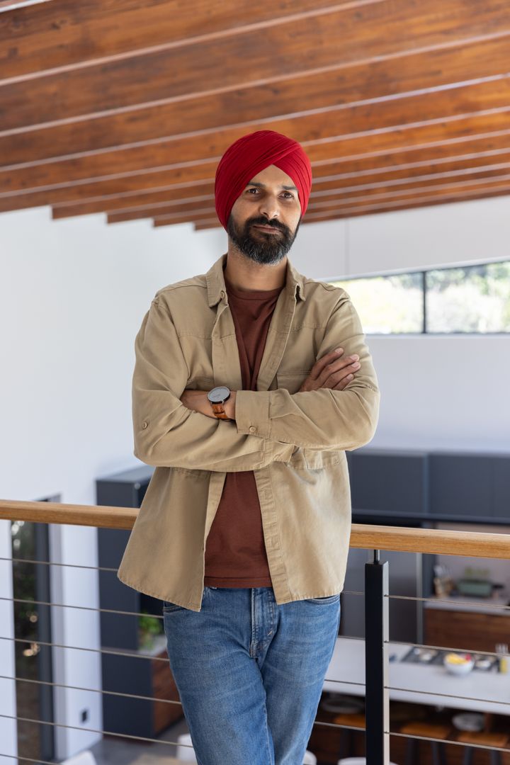 Confident Indian Man Checking Watch on Modern Balcony