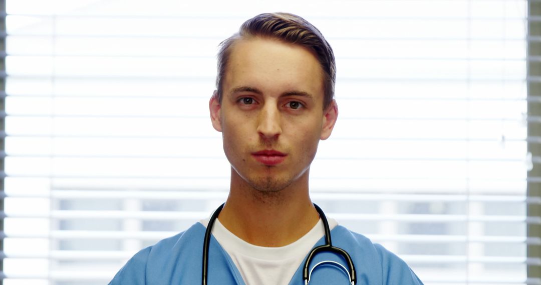 Confident Young Male Doctor Standing in Hospital Room - Free Images, Stock Photos and Pictures on Pikwizard.com