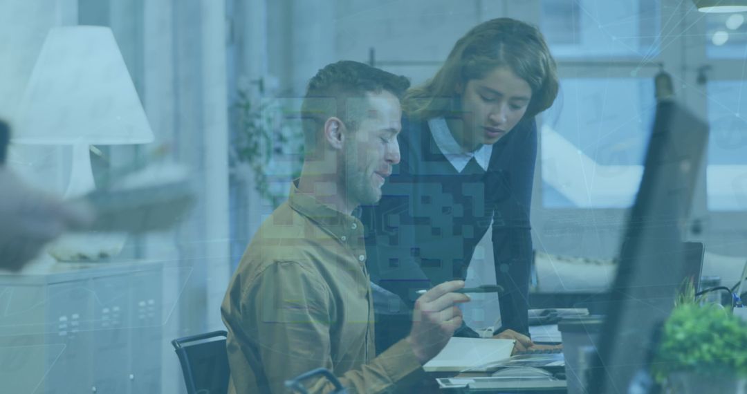 Diverse Professionals Analyzing Data on Desktop at Office