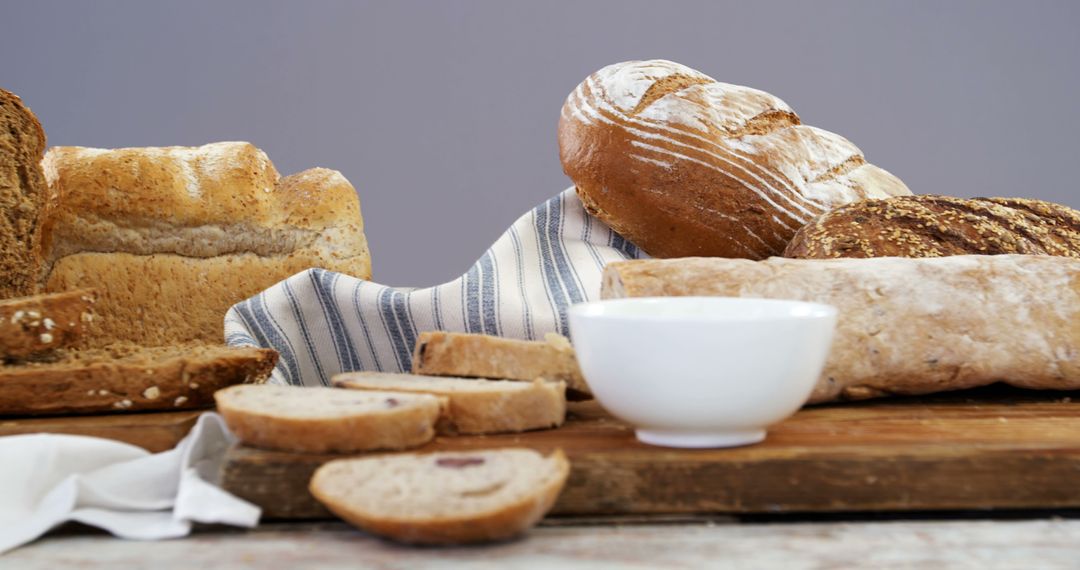 Variety of Freshly Baked Bread on Table with Cloth and Bowl - Free Images, Stock Photos and Pictures on Pikwizard.com