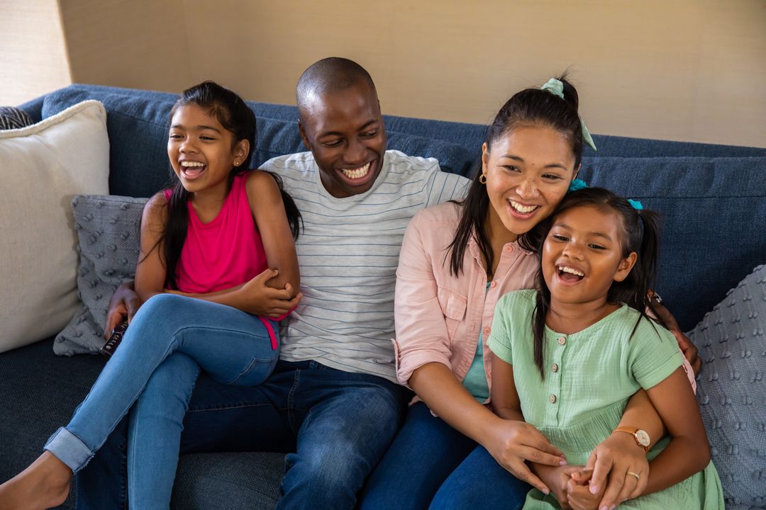 Happy Diverse Family Relaxing on Couch at Home