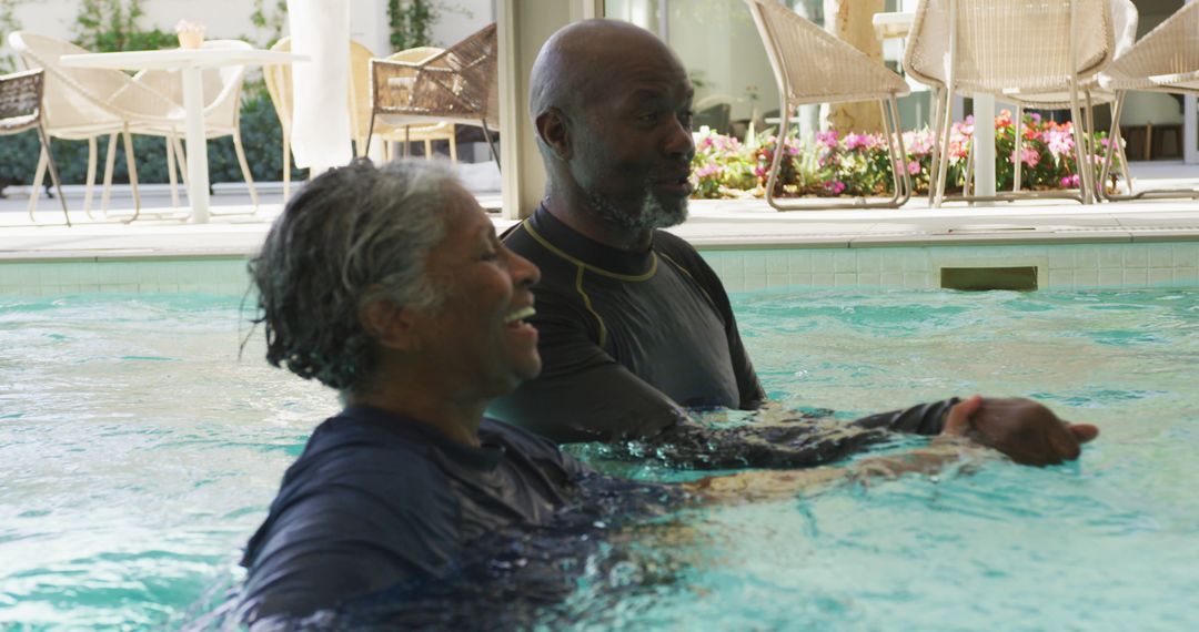 Senior Couple Enjoying Indoor Swimming Pool Together - Free Images, Stock Photos and Pictures on Pikwizard.com