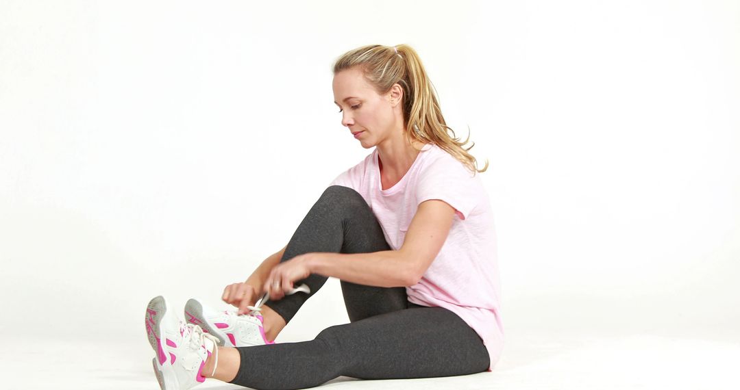 Young Woman Tying Running Shoes During Workout Break - Free Images, Stock Photos and Pictures on Pikwizard.com