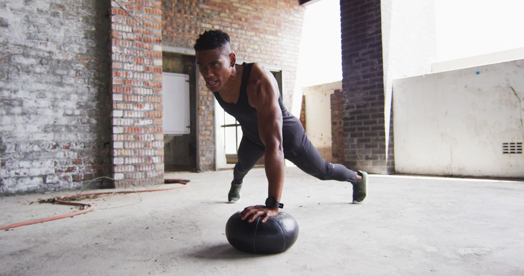 Focused Athlete Performing Medicine Ball Push-Up in Urban Setting - Free Images, Stock Photos and Pictures on Pikwizard.com