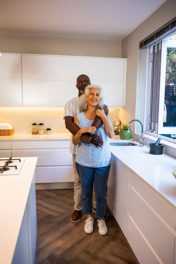 Loving Diverse Couple Embracing in Modern Home Kitchen
