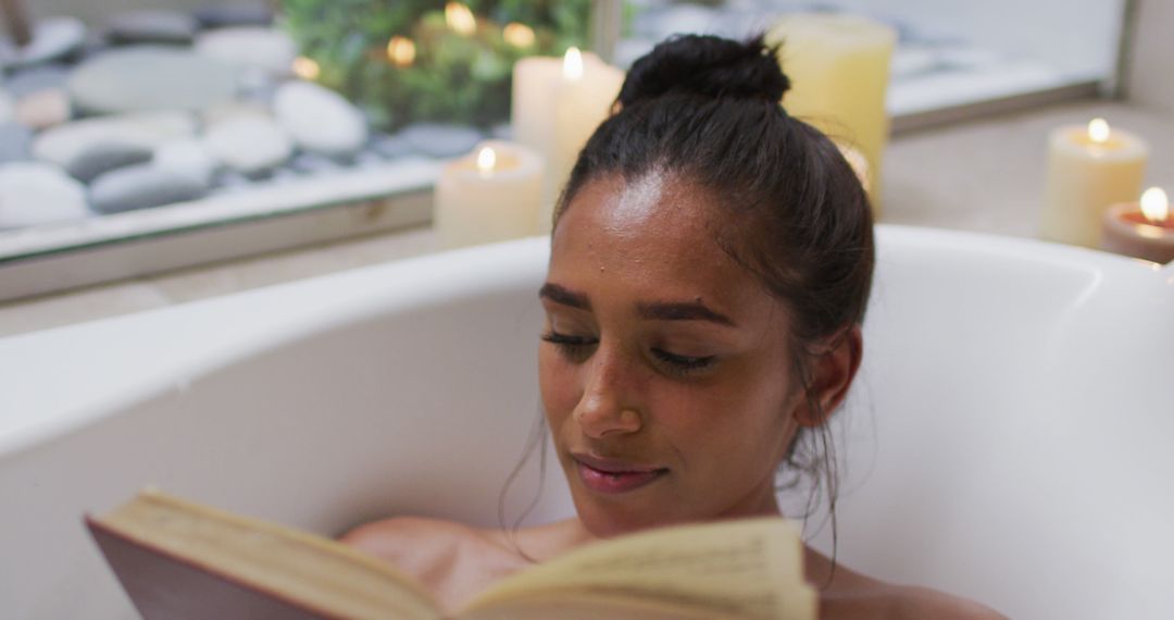 Woman Relaxing in Bath Reading Book with Candles - Free Images, Stock Photos and Pictures on Pikwizard.com