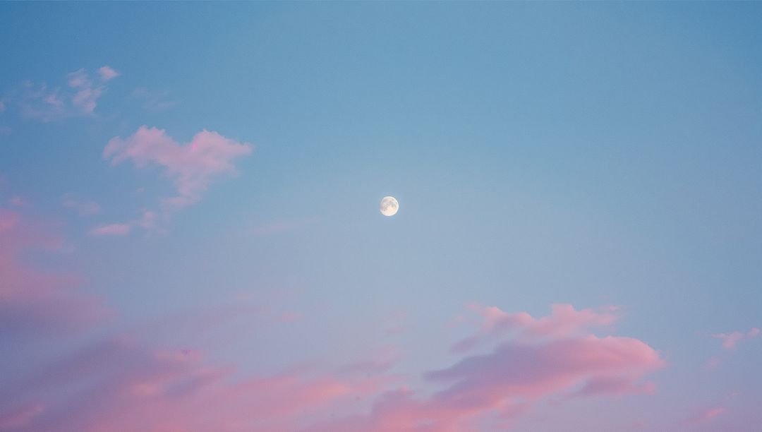 Full Moon in Pastel Twilight Sky with Serene Clouds