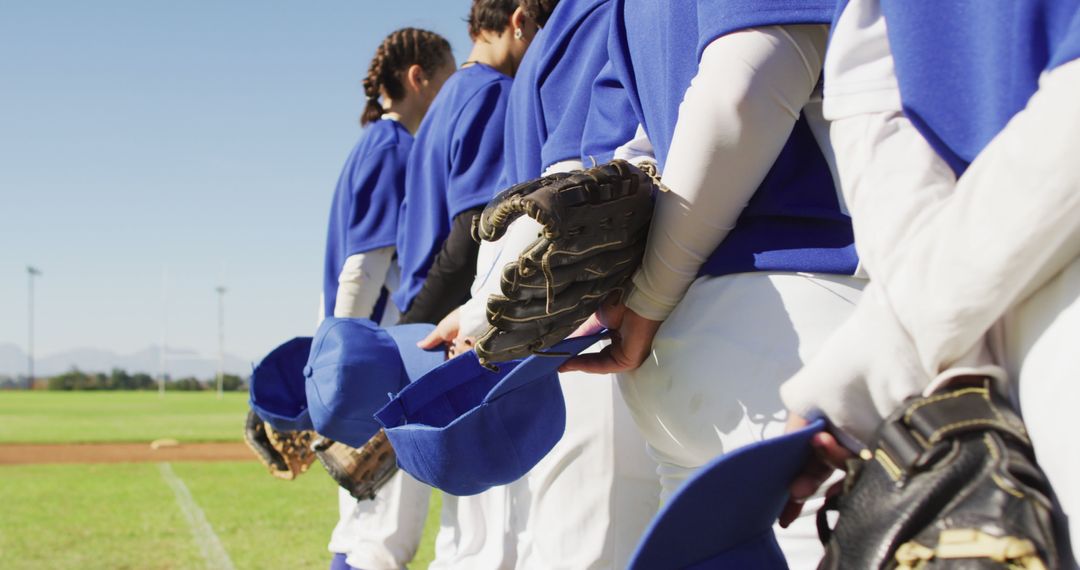 Baseball Team Standing in Line Holding Hats During National Anthem - Free Images, Stock Photos and Pictures on Pikwizard.com