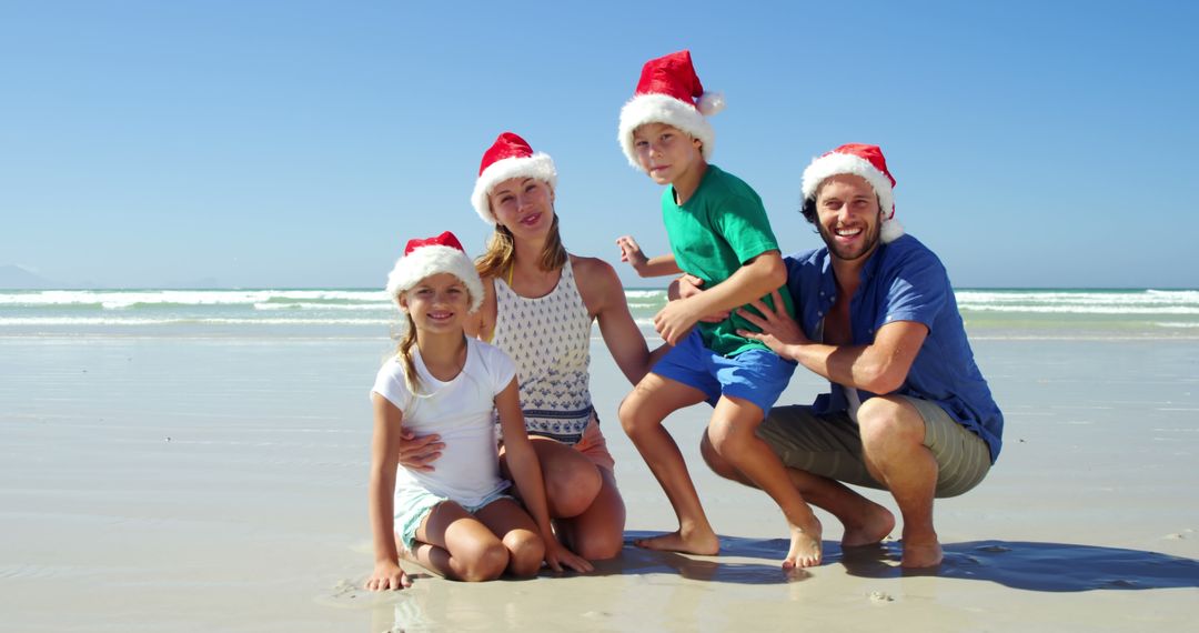 Family Celebrating Christmas on Beach Wearing Santa Hats - Free Images, Stock Photos and Pictures on Pikwizard.com