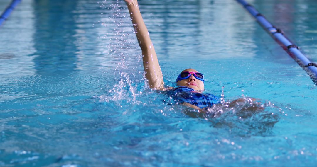 Female Swimmer Practicing Backstroke in Indoor Pool - Free Images, Stock Photos and Pictures on Pikwizard.com