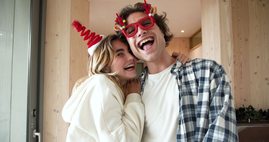Couple Embracing in Festive Headgear Sharing Joyful Moment