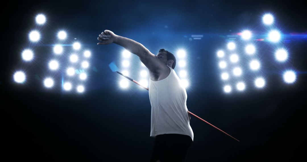 Athlete Throwing Javelin in Stadium Under Bright Lights - Free Images, Stock Photos and Pictures on Pikwizard.com