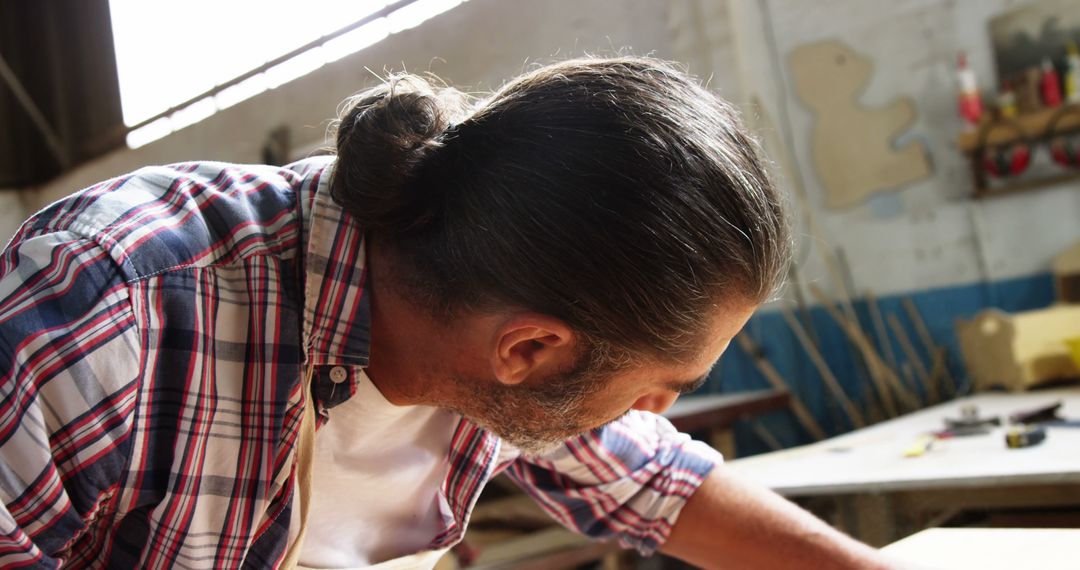 Man Working on Carpentry Project in Workshop with Sunlight - Free Images, Stock Photos and Pictures on Pikwizard.com