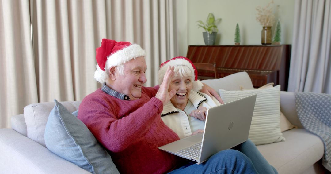 Senior Couple Making Video Call on Christmas Wearing Santa Hats - Free Images, Stock Photos and Pictures on Pikwizard.com