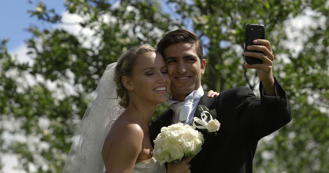 Joyful Bride and Groom Taking Selfie on Wedding Day - Free Images, Stock Photos and Pictures on Pikwizard.com