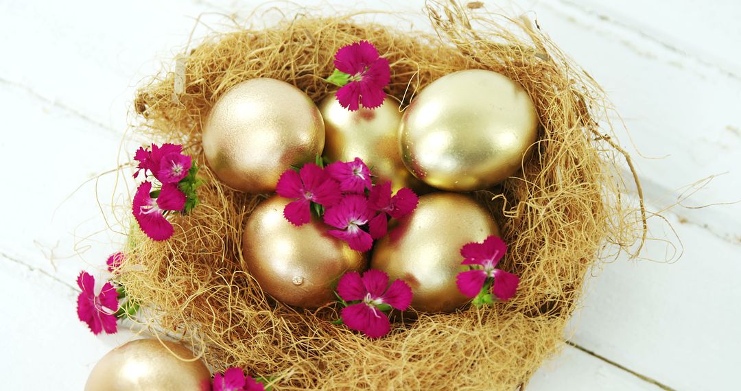 Golden Easter Eggs in Nest with Pink Flowers on White Wooden Background - Free Images, Stock Photos and Pictures on Pikwizard.com