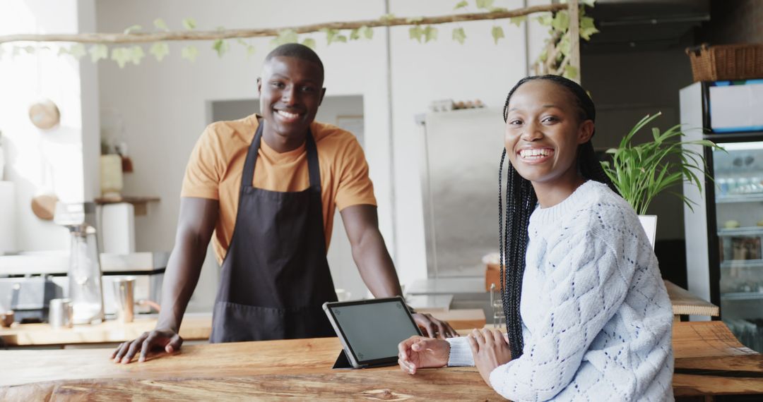 Friendly Coffee Shop Owner Engaging with Smiling Customer