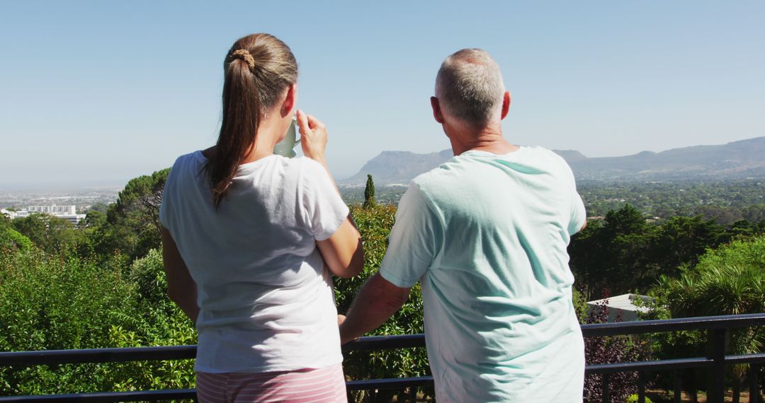 Couple Enjoying Scenic Mountain View from Balcony - Free Images, Stock Photos and Pictures on Pikwizard.com