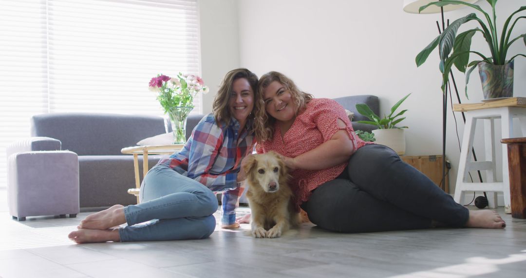 Two women bonding with dog in cozy living room - Free Images, Stock Photos and Pictures on Pikwizard.com