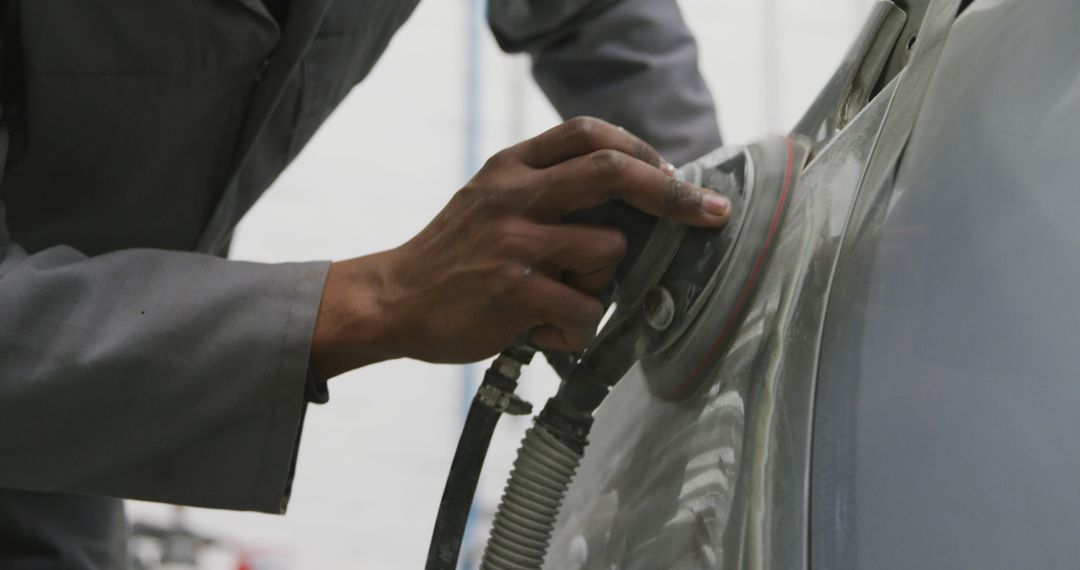 Auto Mechanic Polishing Car Body with Electric Sander - Free Images, Stock Photos and Pictures on Pikwizard.com