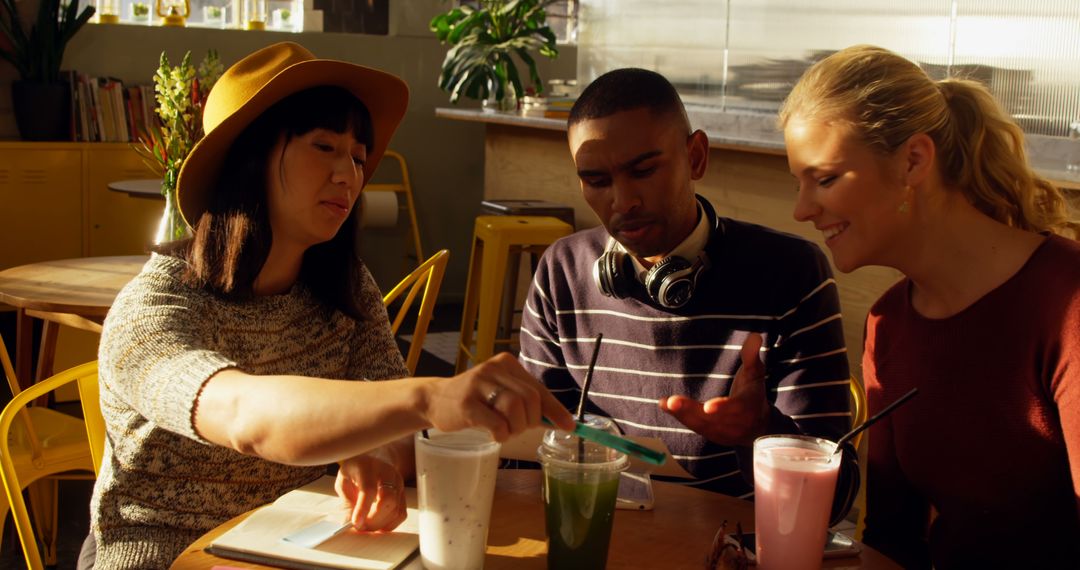 Diverse Team Collaborating in Sunny Cafe Setting