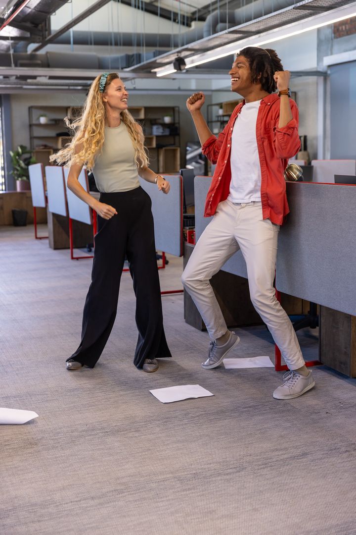 Diverse Office Workers Joyfully Dancing in Creative Workspace