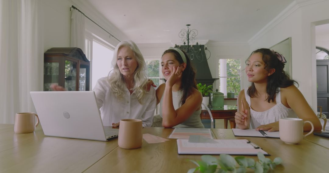 Women Coordinating Wedding Plans at Home with Lively Discussion