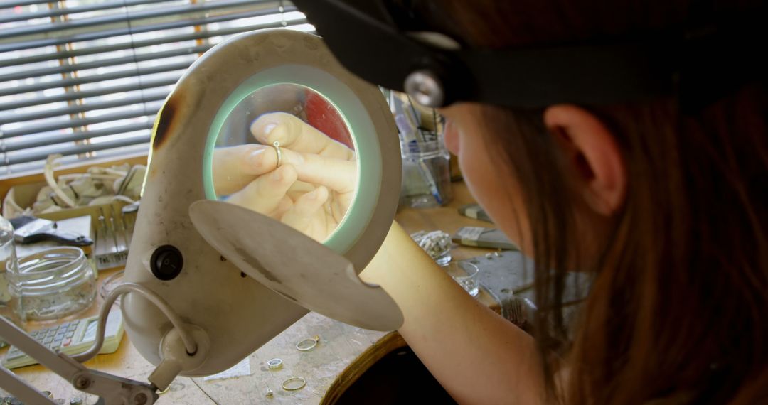 Jeweler Inspecting Ring with Magnifying Glass in Workshop - Free Images, Stock Photos and Pictures on Pikwizard.com