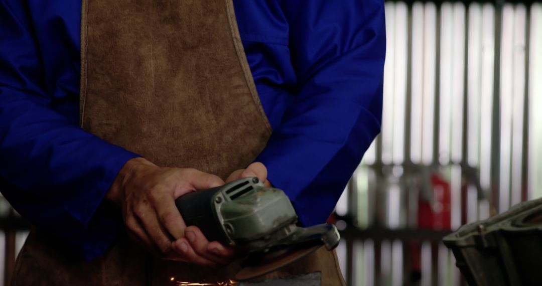 Mechanic Using Grinder in Motorcycle Workshop Focused Repair